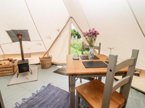 a dining room with a table and a tent at Bluebell in Hereford