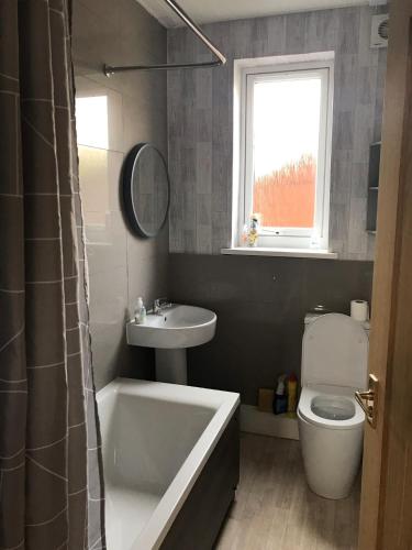 a bathroom with a tub and a sink and a toilet at The Avenue in Eyemouth