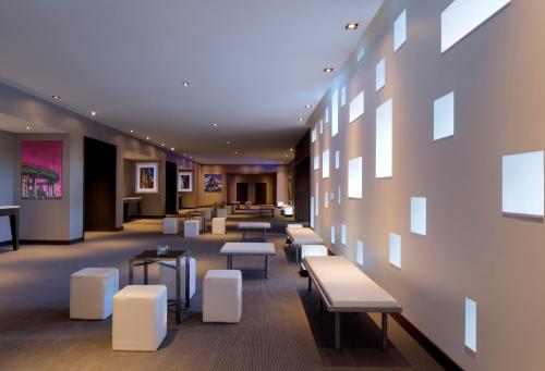 a waiting room with benches and tables in a building at Radisson Blu Mall of America in Bloomington