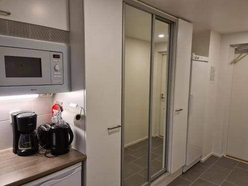 a bathroom with a shower and a microwave at LeviBooking Lost in Levi apt 305 in Kittilä