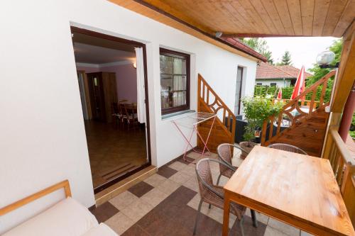 a room with a table and chairs on a balcony at Apartments U Jezera Černá in Černá v Pošumaví