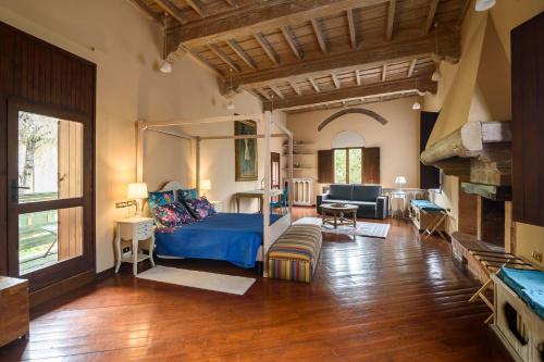 a bedroom with a bed and a living room at Castello di Montonate in Mornago