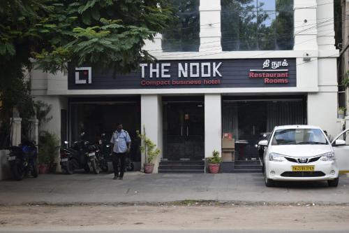a small car parked in front of a building at Hotel The Nook in Madurai