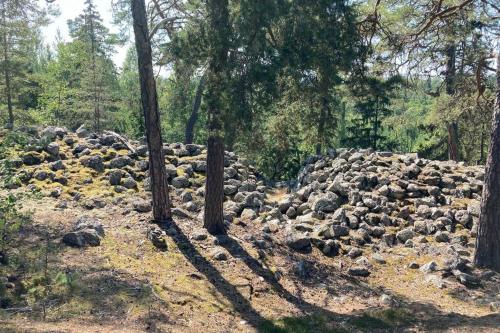 a large pile of rocks in a forest at Cabin in the woods, close to Lake Mälaren in Eskilstuna