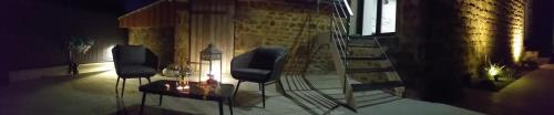 a room with two chairs and a fire place at Le Ptit Spa de L'Abbaye Suite love et Spa privé in Lonlay-lʼAbbaye