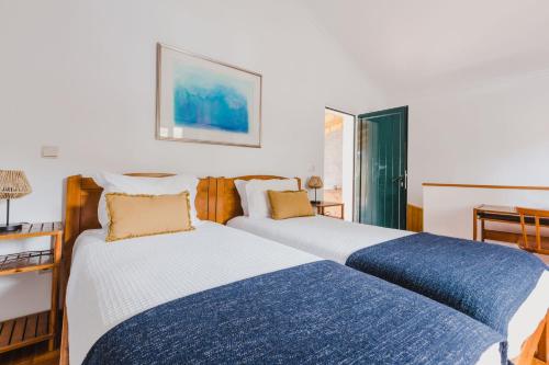 En eller flere senge i et værelse på Casinha do Paiol