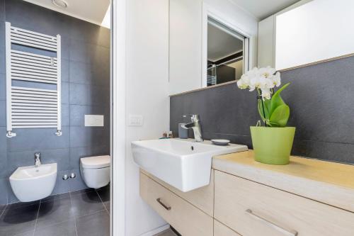 a bathroom with a white sink and a toilet at Milan Retreats in Milan