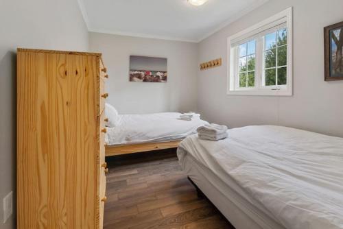 a bedroom with two beds and a window at Scandia Retreat with Hot Tub, Sauna and Fire Pit in Blue Mountains