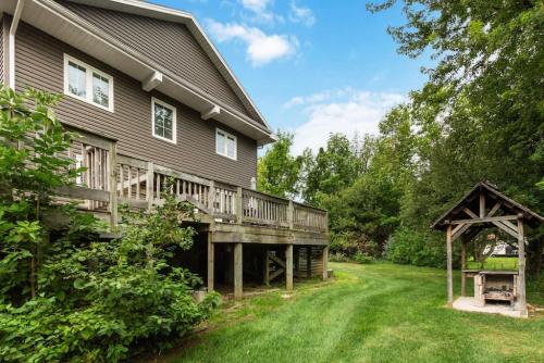 a house with a deck and a gazebo at Scandia Retreat with Hot Tub, Sauna and Fire Pit in Blue Mountains