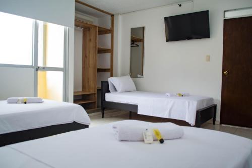 Giường trong phòng chung tại Hotel Centauros del Llano