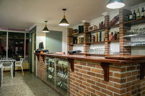 a bar in a restaurant with a brick wall at Hotel Centauros del Llano in Villavicencio