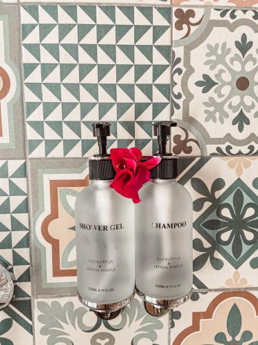two bottles of detergent sitting next to each other at Paje Blu Boutique Hotel in Paje