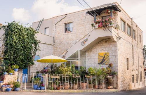 a building with a yellow umbrella in front of it at Khalil lane in the Village in Mi‘ilyā