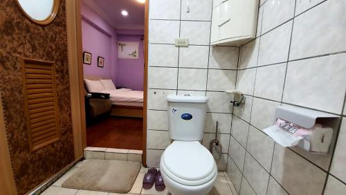 a bathroom with a white toilet in a room at Dongshan River Left Bank in Wujie