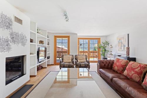 a living room with a couch and two chairs at Chalet Soleil by Mrs Miggins in Champéry