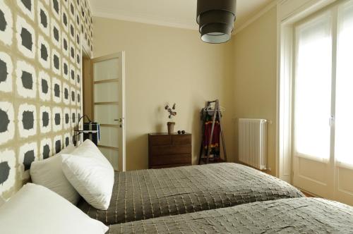 a bedroom with a bed and a large window at Casatitta Bed & Breakfast in Milan