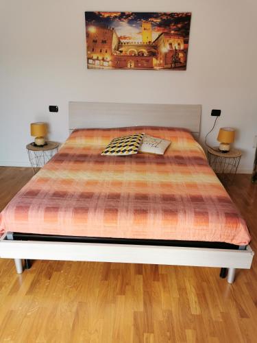 a large bed in a room with two lamps at B&B La terrazza in Ozzano dell Emilia