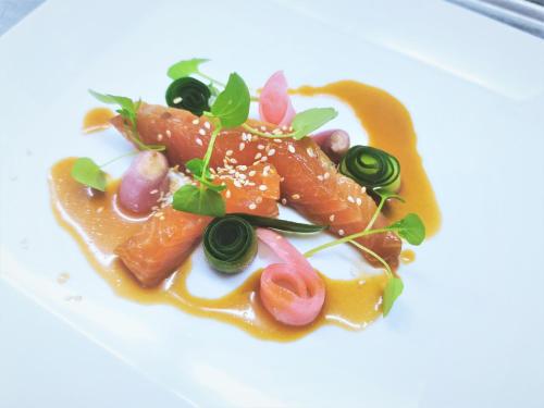 a plate of food on a white plate at Parkhotel Flora am Schluchsee in Schluchsee