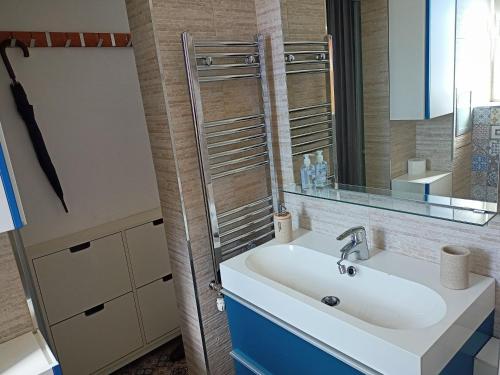 a bathroom with a sink and a mirror at Bright apartment at a great location in Sofia