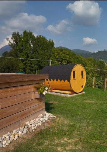a wooden hobbit house in a yard next to a fence at Agriturismo La Soglia Del Parco in Ranica