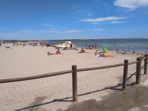 a group of people on a beach near the water at Appartement Meublé bord de mer FOS SUR MER in Fos-sur-Mer