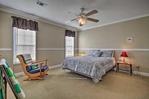a bedroom with a bed and a ceiling fan at Charming Claxton Home Private Deck and Fire Pit! in Claxton