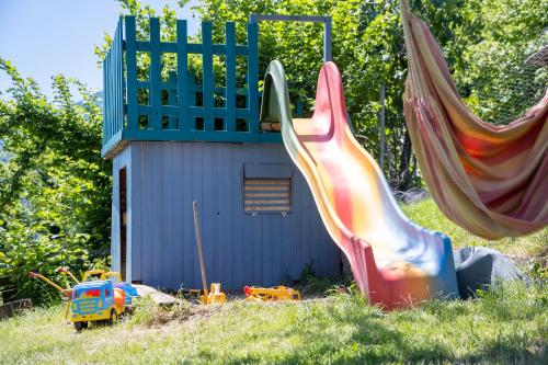 a slide in the grass in front of a building at Unterbrunnerhof in Lana