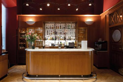 a bar in a room with a lot of bottles at Elite Plaza Hotel in Gothenburg
