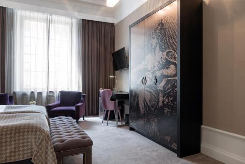 a hotel room with a bed and a table and chairs at Elite Plaza Hotel in Gothenburg