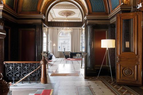 a hallway in a building with a chandelier at Elite Plaza Hotel in Gothenburg