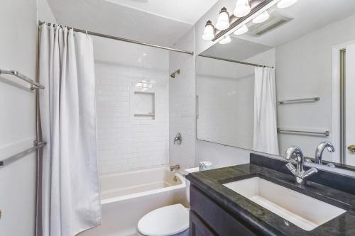 a bathroom with a sink and a toilet and a tub at Pico F305 in Killington