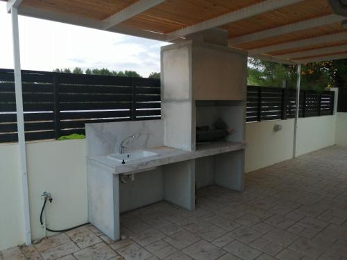 an outdoor kitchen with a sink on a patio at Villa Chrysa in Protaras