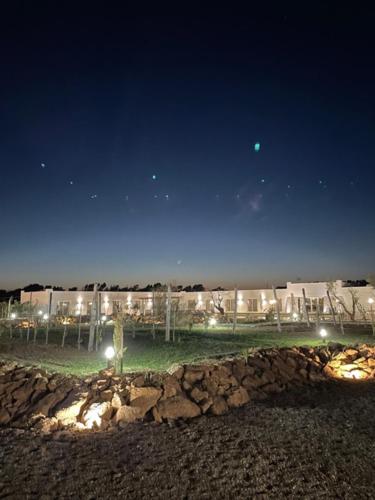 a park at night with a building in the background at Cantine De Mare - Wine and Resort in Cirò Marina