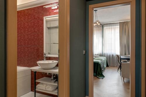a bathroom with a sink and a mirror at Louren - The Bridge Inn in Prague