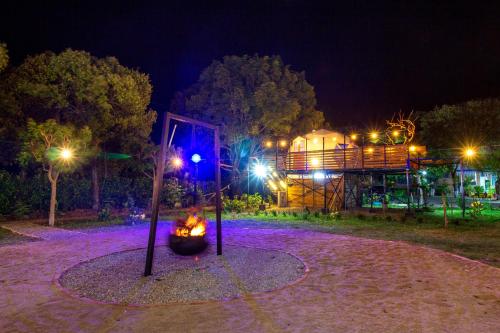a playground at night with a fire in a circle at Glamping Girardot & Hotel Puerta Del Sol Girardot in La Virginia