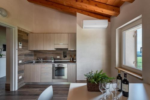 a kitchen with a table with wine glasses on it at Sporting Hotel San Felice in Illasi