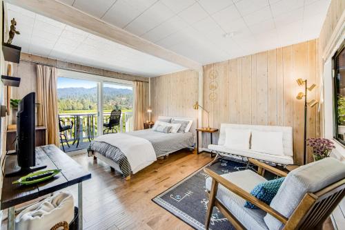 a bedroom with two beds and a balcony at Melody Vineyard Cottage in Guerneville