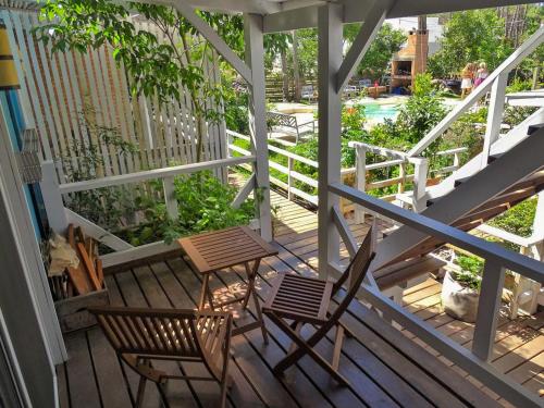 a patio with two chairs and a table on a porch at Il Tano Suites in Punta Del Diablo