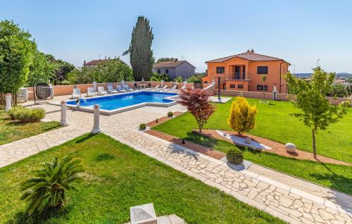 a backyard with a swimming pool and a house at Villa Natalija in Medulin