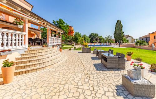 a patio with benches and stairs next to a building at Villa Natalija in Medulin