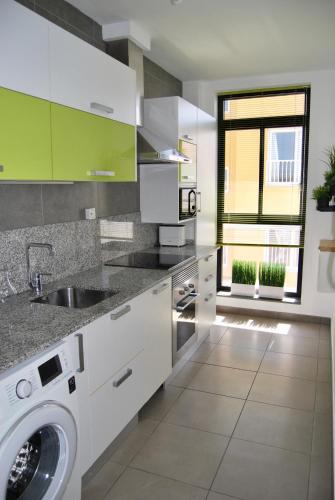 a kitchen with a sink and a washing machine at Casa el Majorero in Puerto del Rosario