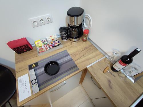 a wooden counter top with a coffee maker on it at Passion by Nights & Smiles in Tuzla