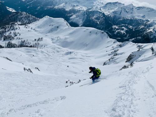 a person is skiing down a snow covered mountain at Bergkristallhaus in Ramsau am Dachstein