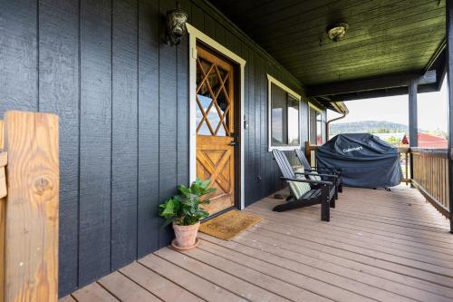 a porch of a house with a bench and a door at Whispering Hollow Lodge on Greer Main St! in Greer