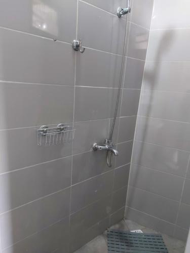 a shower in a bathroom with a tile wall at CiRa in Dakar