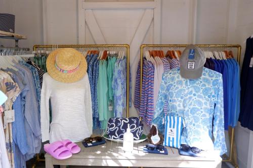 a clothing store with clothes and hats on racks at Lovango Resort and Beach Club in Cruz Bay
