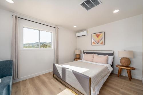 a bedroom with a bed and a window at @ Marbella Lane - Rainbow House Glampers Paradise in Joshua Tree