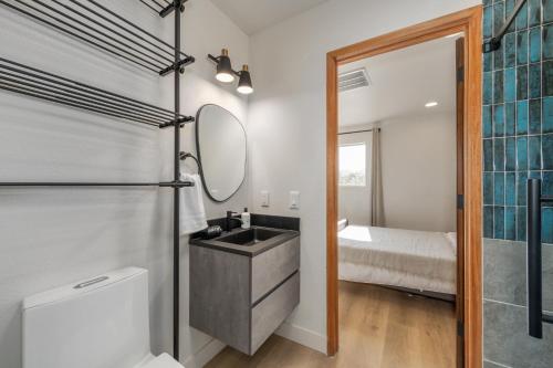 a bathroom with a sink and a mirror at @ Marbella Lane - Rainbow House Glampers Paradise in Joshua Tree