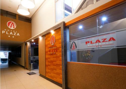 a pizza shop with a pizza sign on the side of a building at Hotel Plaza in Tacna