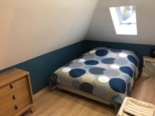 a bedroom with a bed with a polka dot sheets at Maison cosy entièrement rénovée in Aumale